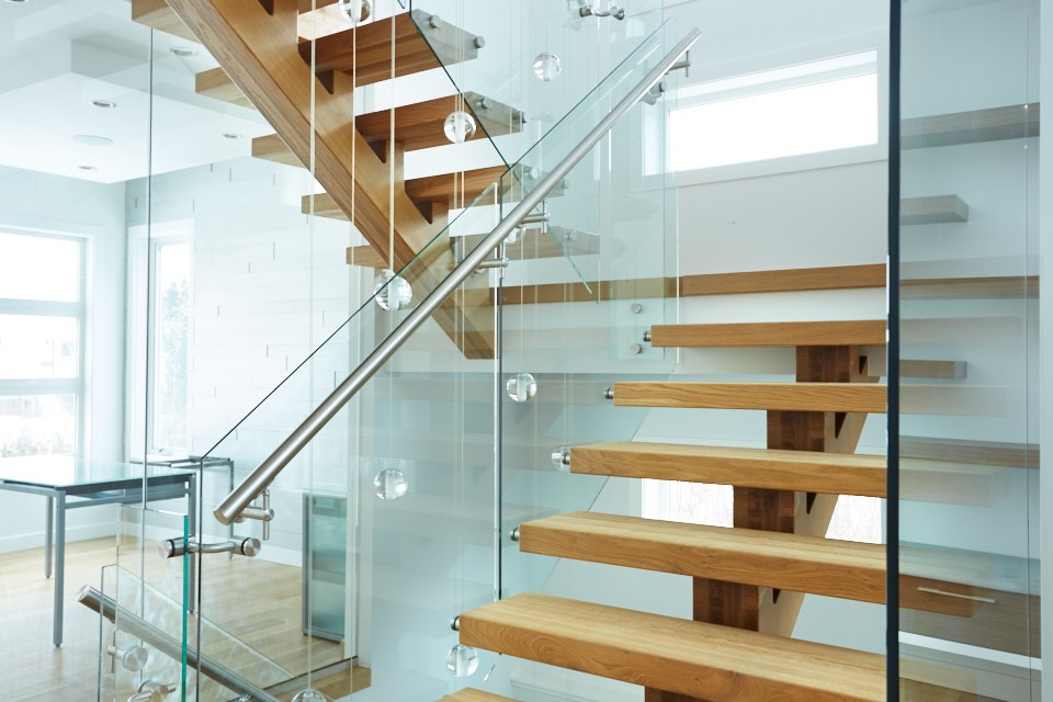 Glass railing with a handrail